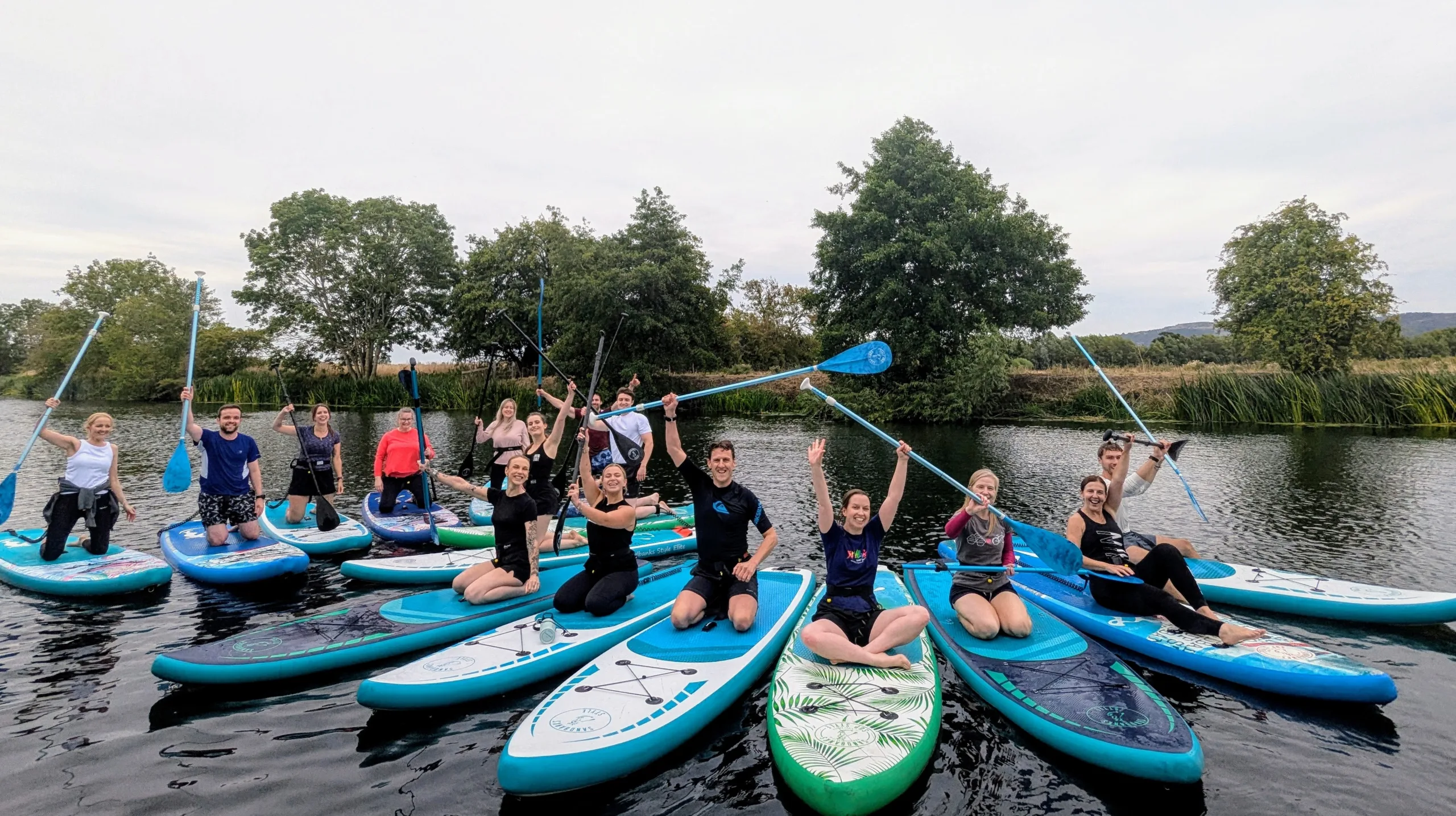 Corporate paddleboarding team day on the river